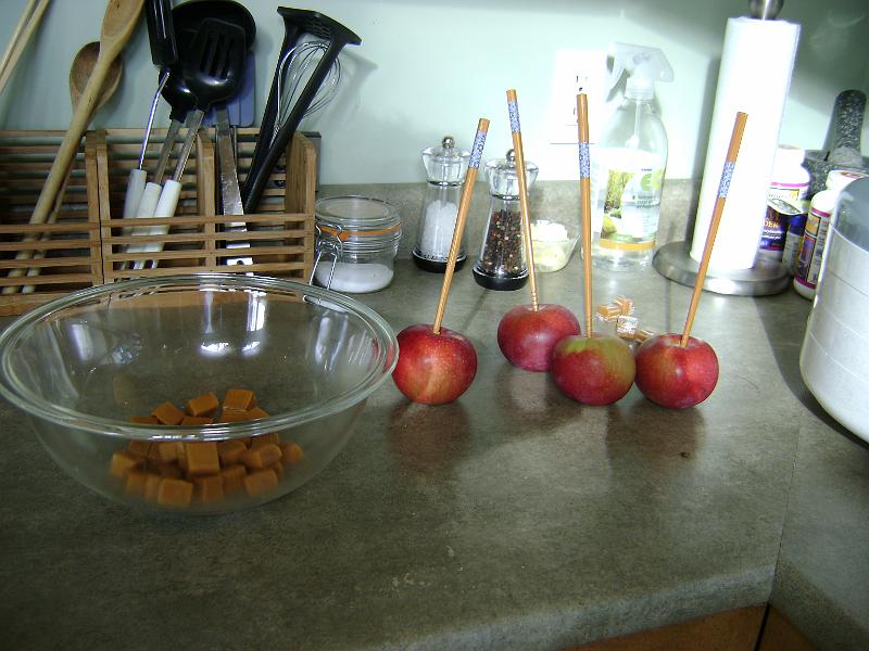 DSC03586.JPG - We walked down the street to an orchard. We bought about 30 apples for $4. Then Rebecca turned these four into caramel apples.
