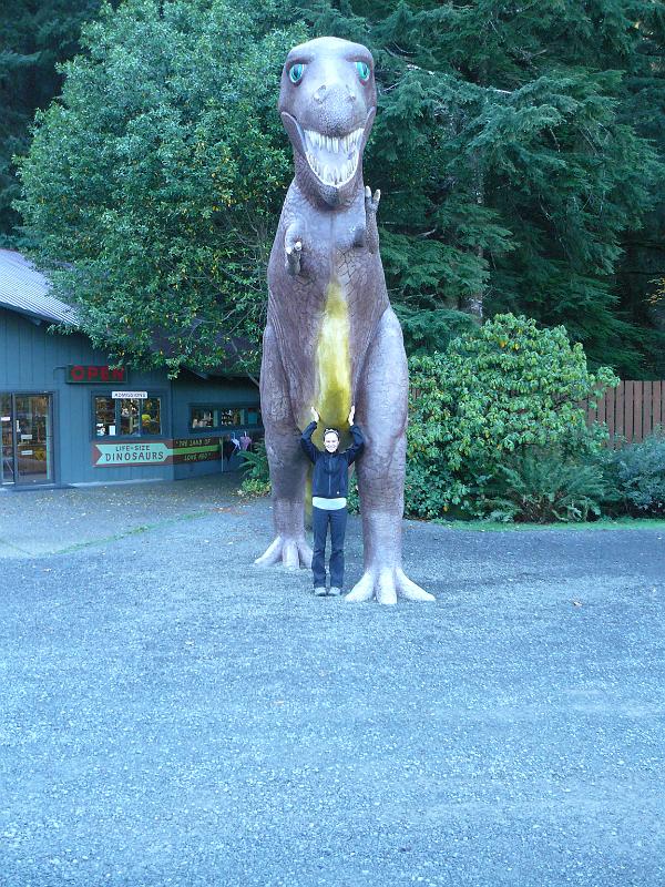 P1060540.JPG - We stopped at this bizarre theme park that just had model dinosaurs throughout the forest. We didn't want to pay the eight bucks so we just got Queeb's photo in front of the big T-Rex