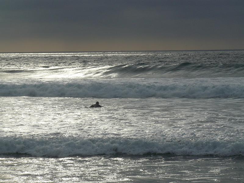 P1070925.JPG - Andrew paddling out into the rough and unforgiving seas to catch that perfect wave and ride it into eternity